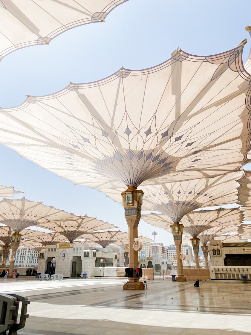 Al-Masjid an-Nabawi courtyard in Medina, with shade umbrellas and marble plaza