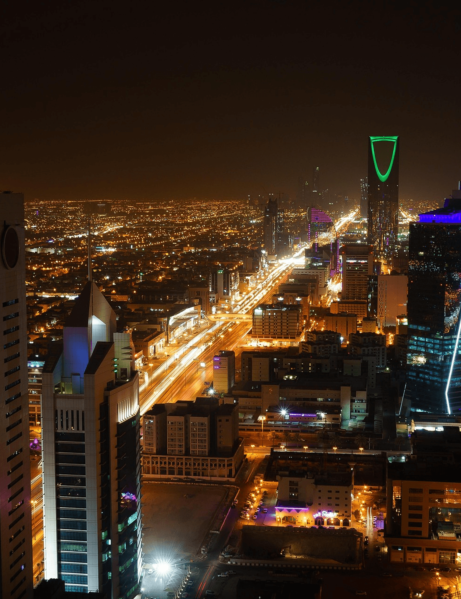 Riyadh city skyline at night with highways and the Kingdom Centre tower